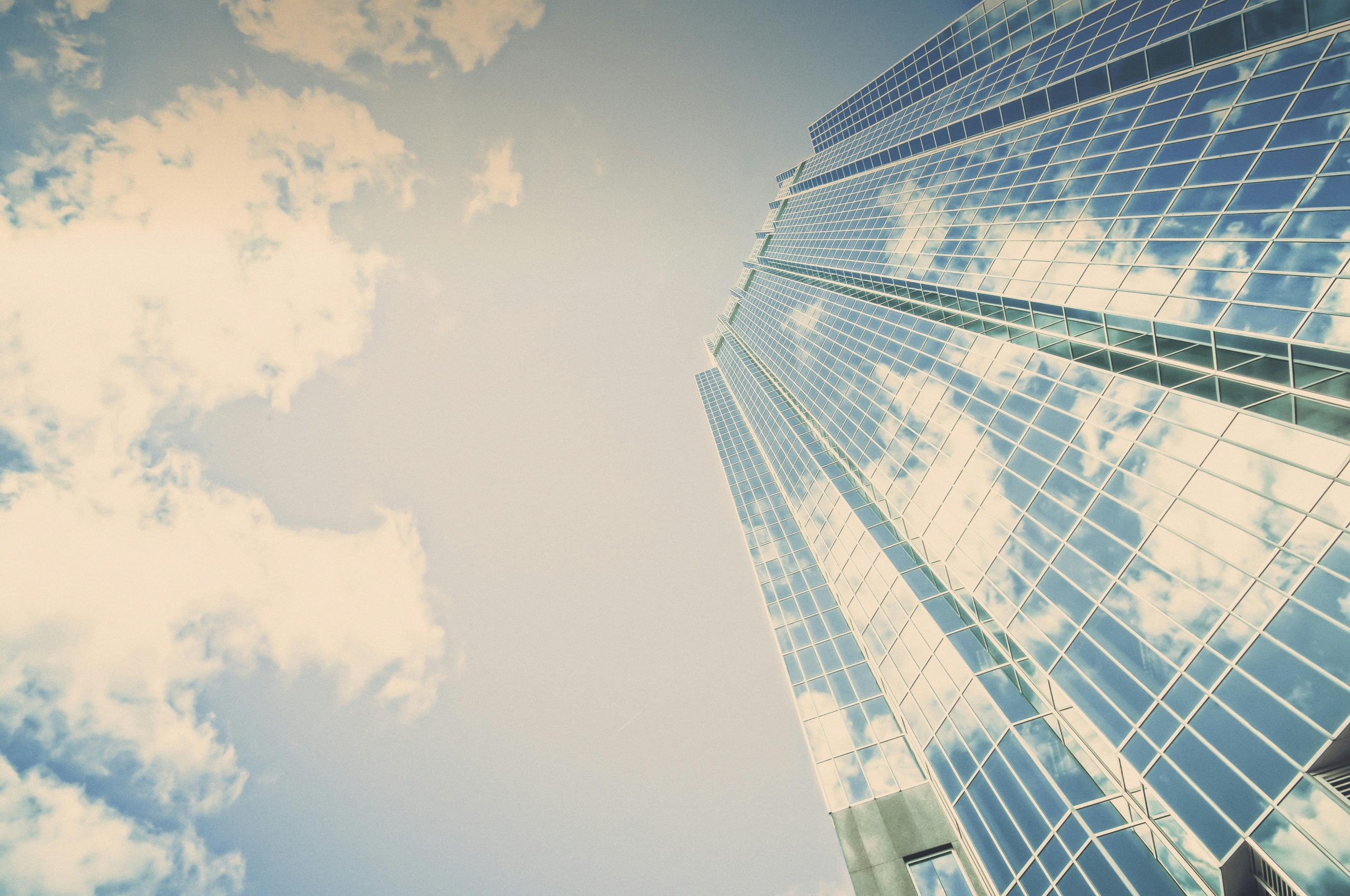 Upward View of a Skyscraper with the sky in the background. 